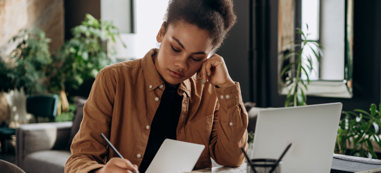 Woman writing down some of the best cities for singles in NJ
